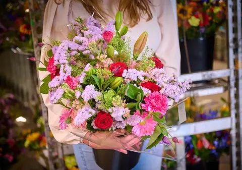 A colourful mixed bouquet held in two hands